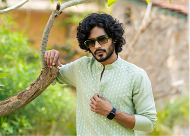 Traditional groom style model in green embroidered sherwani